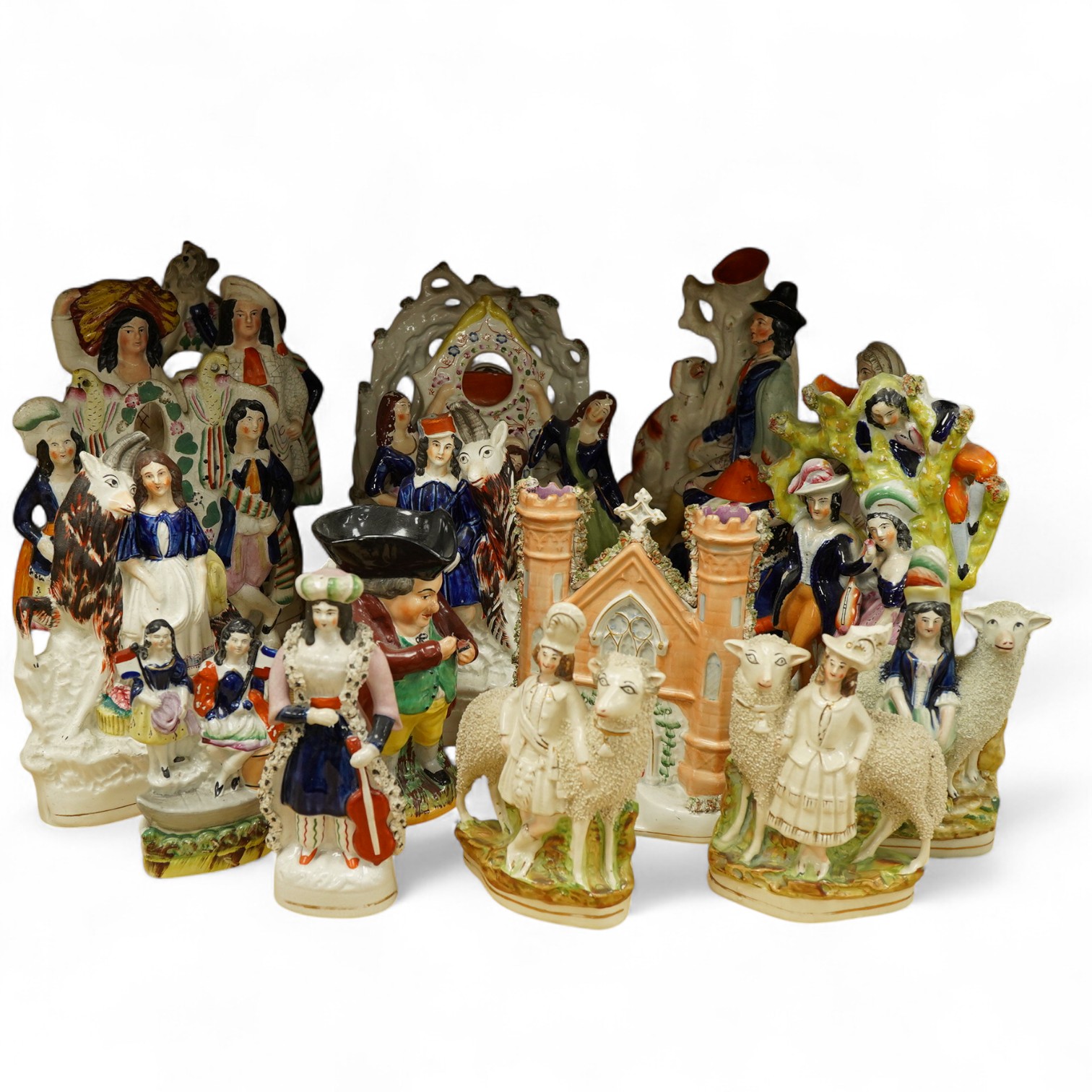 A collection of Victorian Staffordshire pottery figures, largest 32cm high